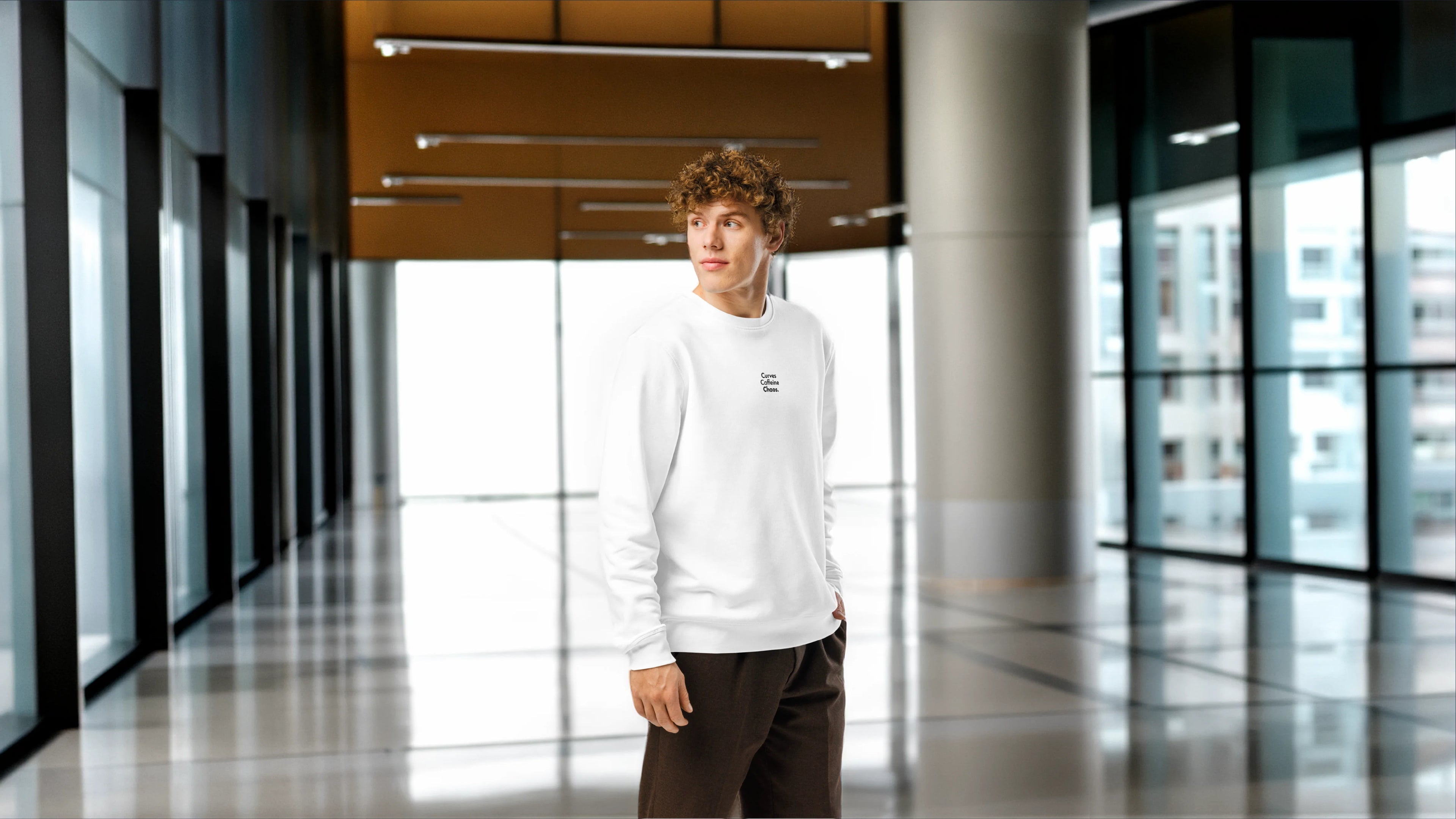 Person wearing a white sweatshirt in a modern indoor setting